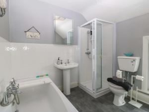 a bathroom with a shower toilet and a sink at Jack's House in Tywyn +31 photos