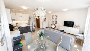 a living room with a dining table and a kitchen at K&D in Rijeka