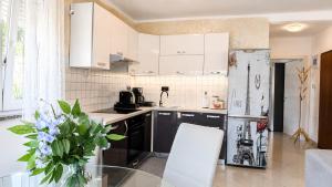 a kitchen with a glass table and a refrigerator at K&D in Rijeka +7 photos