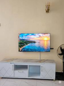 a flat screen tv sitting on a wall in a living room at Sky-Host, Dulham suite in Homa Bay