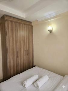 a bedroom with a bed with two white pillows at Sky-Host, Dulham suite in Homa Bay