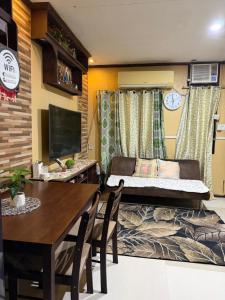 a living room with a dining table and a couch at My Humble Home in Dipolog