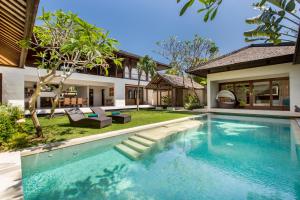 a swimming pool in the backyard of a house at Villa Air Bali Boutique Resort and Spa in Seminyak