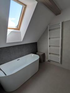 a white bath tub in a bathroom with a window at Apartmány Vysoké in Vysoké nad Jizerou +31 photos