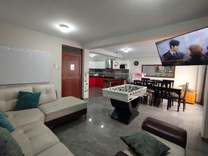 a living room with a couch and a table at Apartamentos "APPART D'ELIETTE" in Trujillo