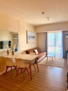 a living room with a table and chairs and a couch at Avida Towers Riala Tower 1 in Cebu City