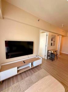a living room with a large flat screen tv at Avida Towers Riala Tower 1 in Cebu City