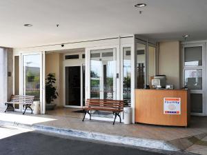 a lobby with two benches in front of a building at ibis Sao Paulo Interlagos in São Paulo +81 photos