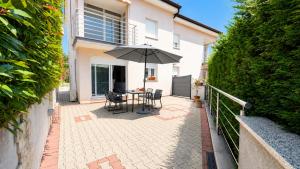a patio with a table and an umbrella at K&D in Rijeka