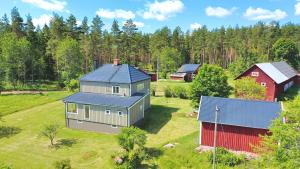 an aerial view of a house and a barn at Hus Stora Hultet in Hultsfred