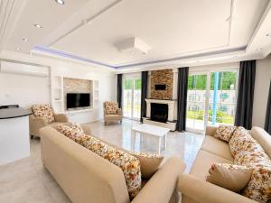 a large living room with couches and a fireplace at Villa Fergana in Oludeniz