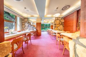 a row of tables and chairs in a restaurant at Hotel Velveta in Špindlerův Mlýn