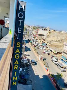 a view of a city with a sign on a building at Hotel sagar inn in Ajmer