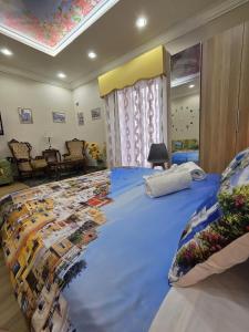a bedroom with a large bed with a blue comforter at Maison de Ciro in Gragnano