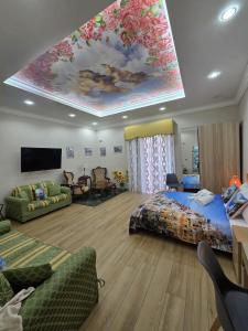 a large room with a bed and a painting on the ceiling at Maison de Ciro in Gragnano