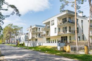 an apartment building on the side of a street at Baltic Apartments in Pobierowo