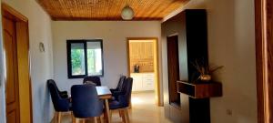 a dining room with a table and blue chairs at Casa in Durrës