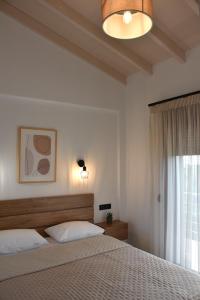 a bedroom with a large bed and a window at Saonia Apartment in Samothraki