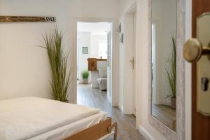 a bedroom with a bed and a hallway at Syltliebe in Westerland