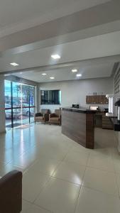 a large room with a lobby with couches and a counter at Hotel 2001 in Iraí de Minas