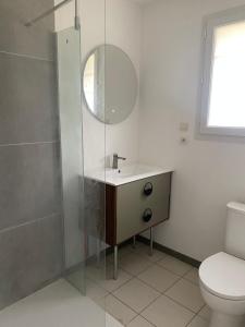 a bathroom with a sink and a shower with a mirror at Fre&dom in Lacanau +9 photos