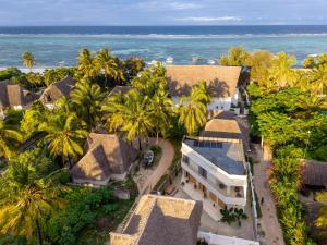 an aerial view of a house with palm trees and the ocean at Nishati - Private Beach Villa in Matemwe