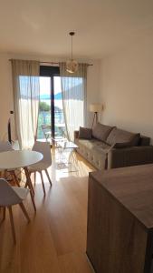 a living room with a couch and a table at Azure Bay Apartments in Donja Lastva