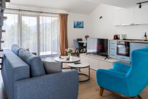 a living room with a couch and a tv at Hill House Orahovac in Kotor