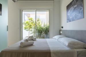 a bedroom with a large bed with towels on it at Sublimare Luxury Apartments in Giulianova