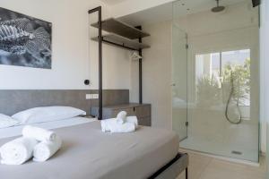 a bedroom with two beds and a glass shower at Sublimare Luxury Apartments in Giulianova +226 photos