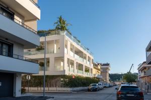 a white building with a tree on the top of it at Sublimare Luxury Apartments in Giulianova