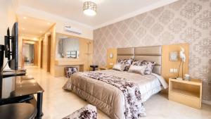 a bedroom with a large bed and a television at Luxury family apart parc plaza Mohammedia in Mohammedia