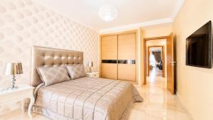 a bedroom with a large bed and a television at Luxury family apart parc plaza Mohammedia in Mohammedia