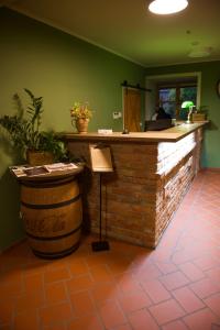 a bar in a restaurant with a counter and a barrel at Hotel Stork in Lednice