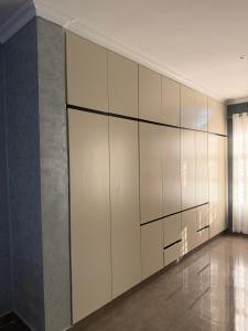 a large wall of white cabinets in a room at MAI instahomes in Lilongwe