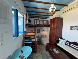 a small room with a bunk bed and a bathroom at John's View in Serifos Chora