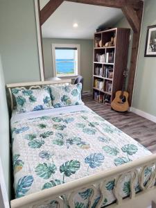 a bedroom with a bed and a guitar in a room at Ocean Pines seaside cottage in Shelburne