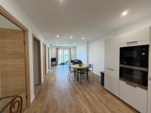 a kitchen and dining room with a table and chairs at Charmant appartement sur les hauteurs d'Erbalunga in Brando