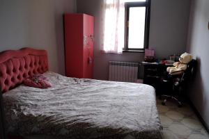 a bedroom with a red bed and a desk at Tsikhisdziri House 3 in Ts'ikhisdziri