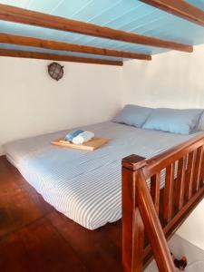 a bed with a wooden frame in a room at John's View in Serifos Chora
