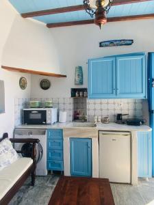 a kitchen with blue cabinets and a sink at John's View in Serifos Chora +4 photos