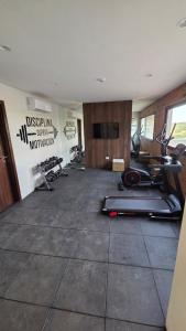 a gym with treadmills and exercise bikes in a room at #5 Monoambiente, Pool, Grill, Gym, Sauna in Nu Guazu