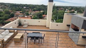 a balcony of a house with a table and chairs at #5 Monoambiente, Pool, Grill, Gym, Sauna in Nu Guazu +1 photo