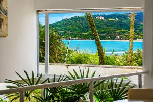 a view of the ocean from a window at Savay Hotel Boutique - Guarujá in Guarujá