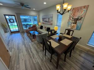 a dining room and living room with a table and chairs at CW C101 Condo de Comal in New Braunfels