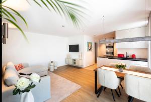 a living room and kitchen with a couch and a table at Nomes Apartment in Axams