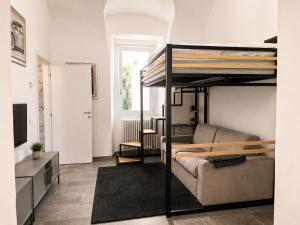 a living room with a bunk bed and a couch at Ca del Lac, few steps from Lake Maggiore in Porto Valtravaglia