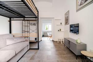 a living room with a couch and a tv at Ca del Lac, few steps from Lake Maggiore in Porto Valtravaglia