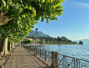 a sidewalk next to a body of water at Ca del Lac, few steps from Lake Maggiore in Porto Valtravaglia