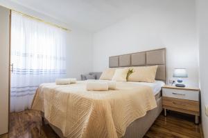 a bedroom with a large bed and a window at Markovi A&V in Gevgelija +19 photos